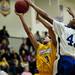 Ypsilanti junior Janeau Joubert is blocked by Pioneer senior Tevis Robinson in the game on Monday, March 4. Daniel Brenner I AnnArbor.com
